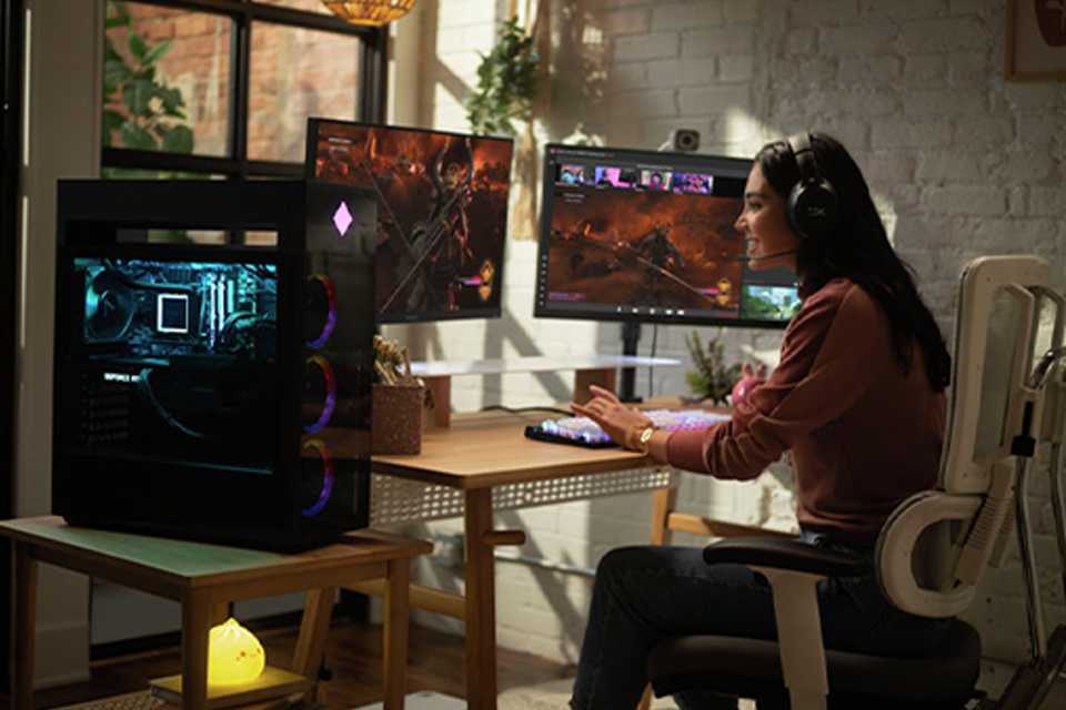 A girl playing video games on an HP gaming PC with 2 monitors.
