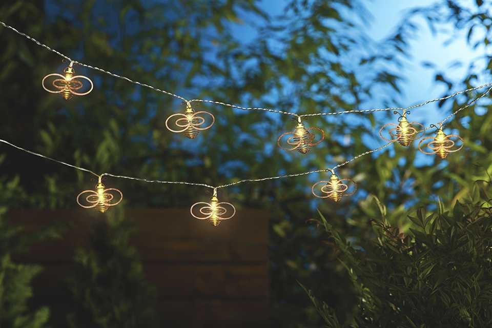 LED solar string lights hanging in a garden.