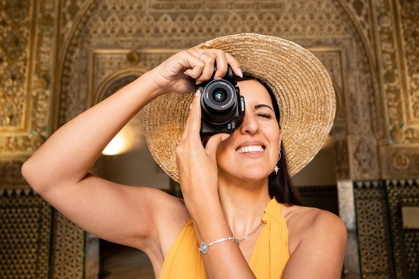 Man taking a photograph with a Canon EOS M50 MK II Mirrorless camera.
