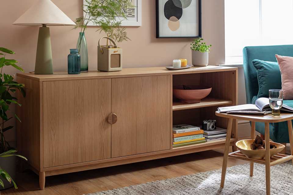 A 2-door oak sideboard sitting in a living room.