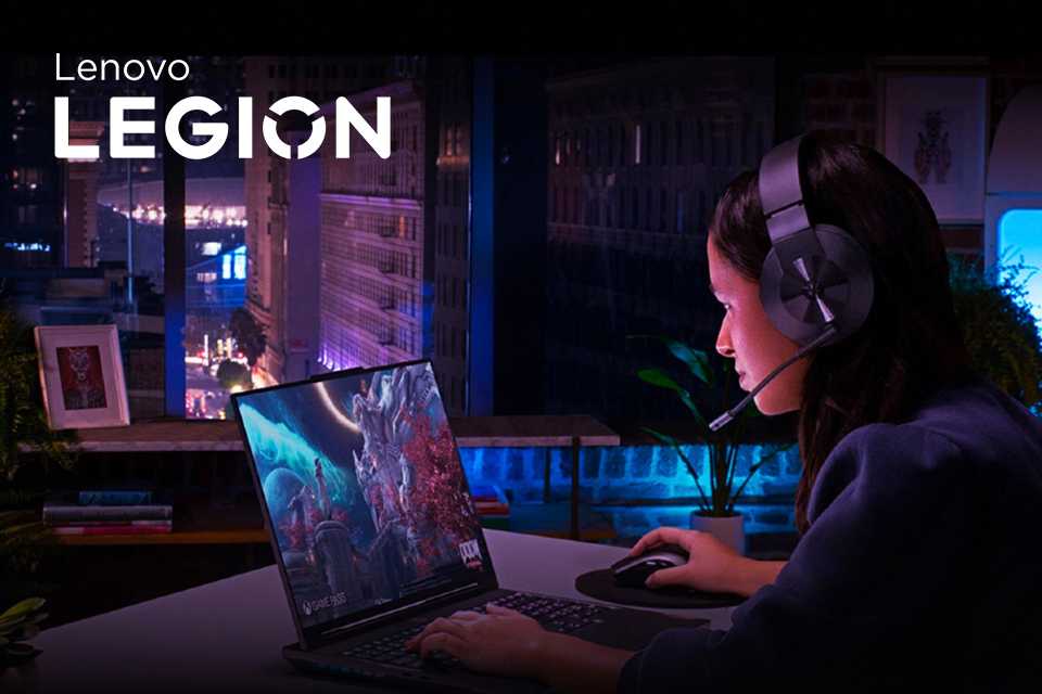 A woman gamer on a Lenovo Legion computer late at night.
