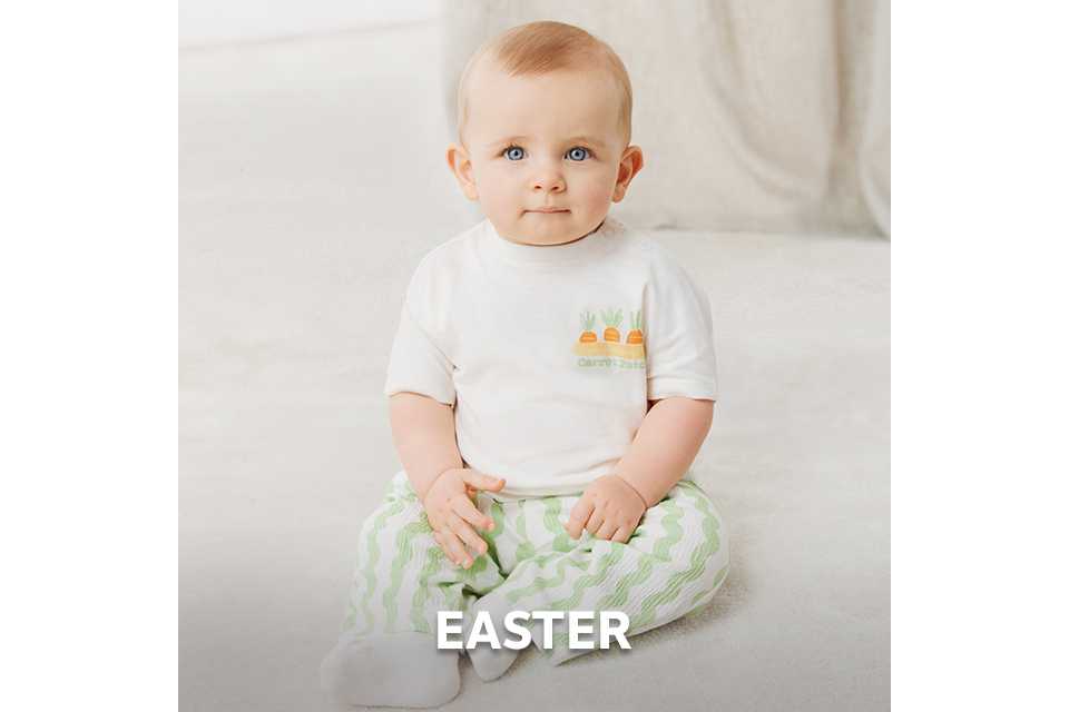 Baby wearing a white short‑sleeve T‑shirt with carrot print and green striped trousers for spring outfits.