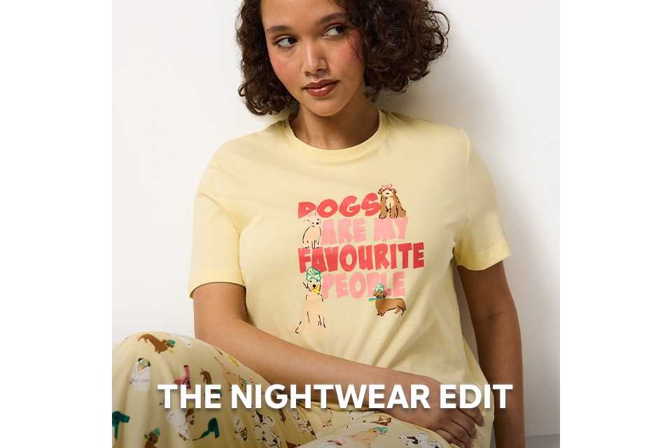 Person wearing pink nightwear top with a subtle heart pattern from the nightwear edit.