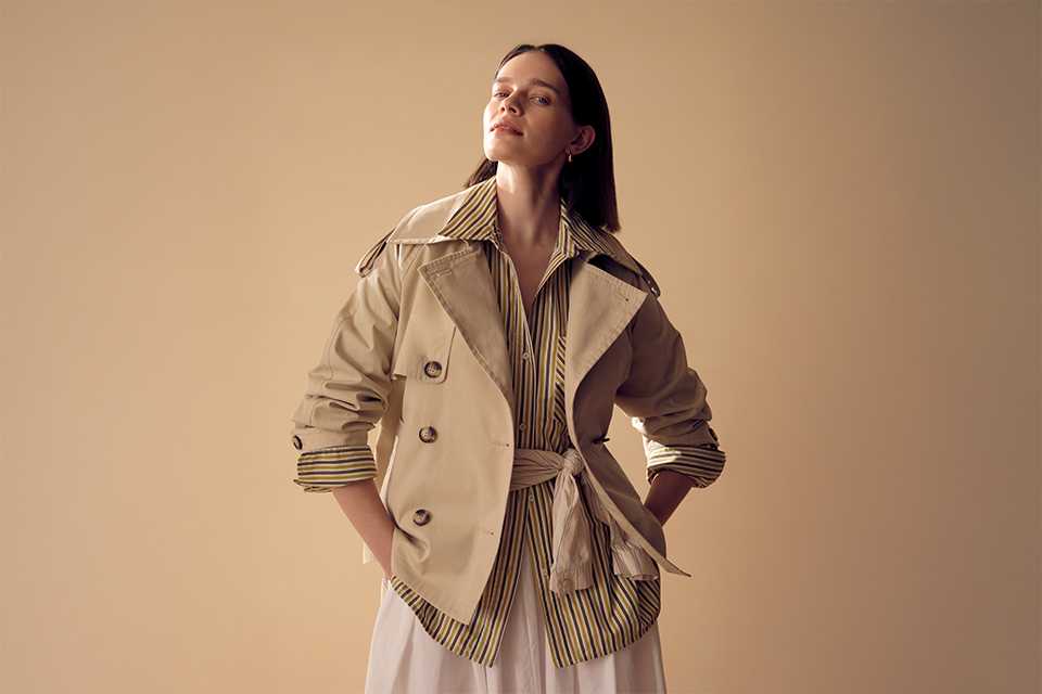 Light spring outfit featuring a beige utility jacket layered over a neutral top with relaxed trousers, styled for everyday transitional dressing.