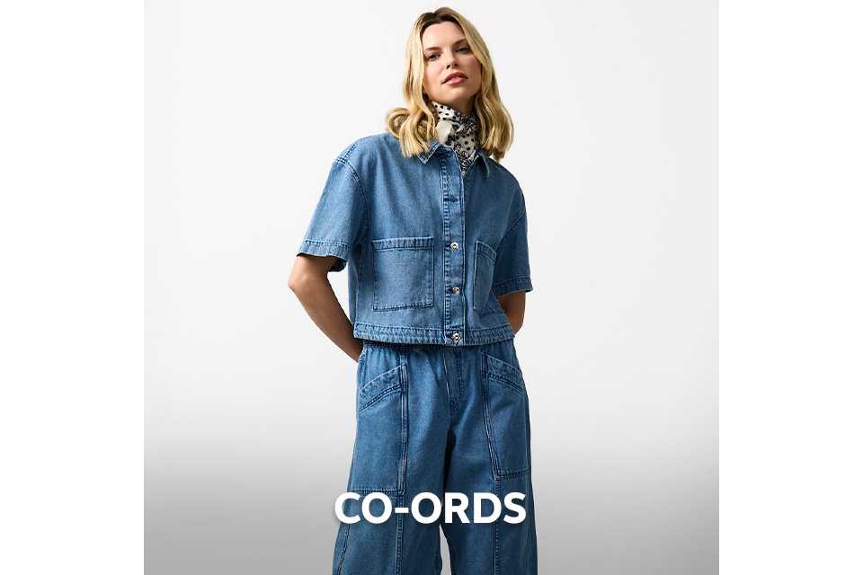 Denim co‑ord featuring a short‑sleeve cropped jacket and wide‑leg jeans styled with a patterned necks.