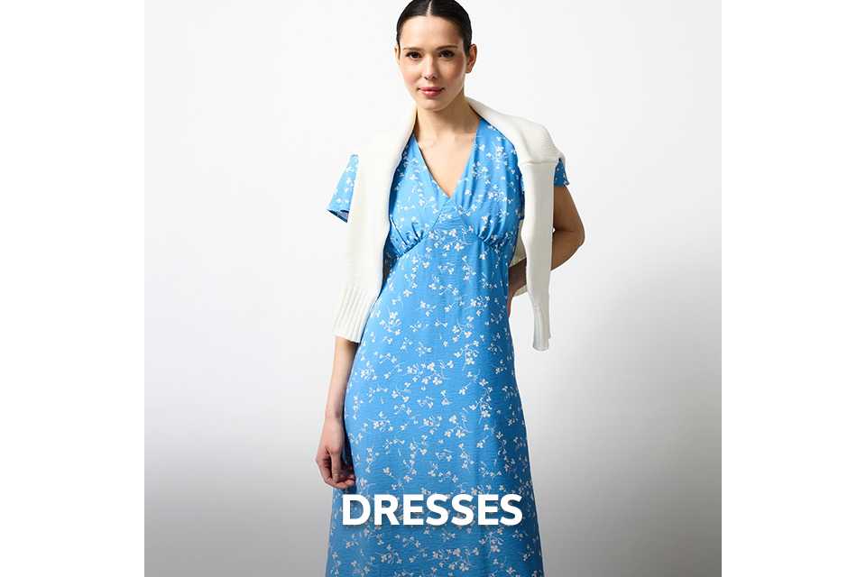 Blue floral midi dress with V-neck detail styled with a white knit sweater for spring and summer weddings.