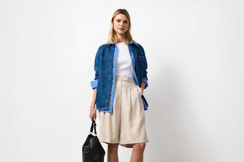 Everyday summer outfit featuring a denim shirt layered over a light dress, ideal for versatile warm‑weather styling.