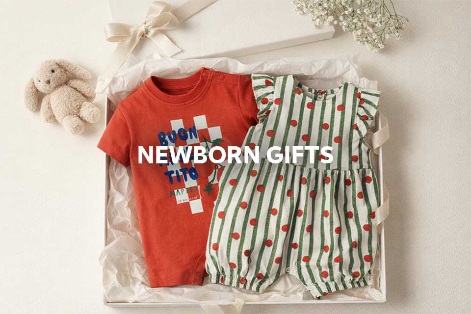 Newborn gift set with baby outfit and essentials wrapped for gifting.