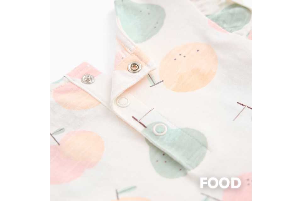 Baby sleepsuit with playful food print.