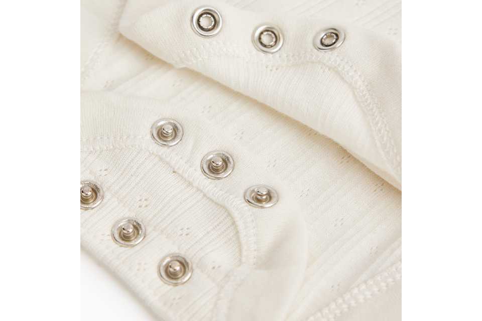 Baby sleepsuit with easy popper fastenings.