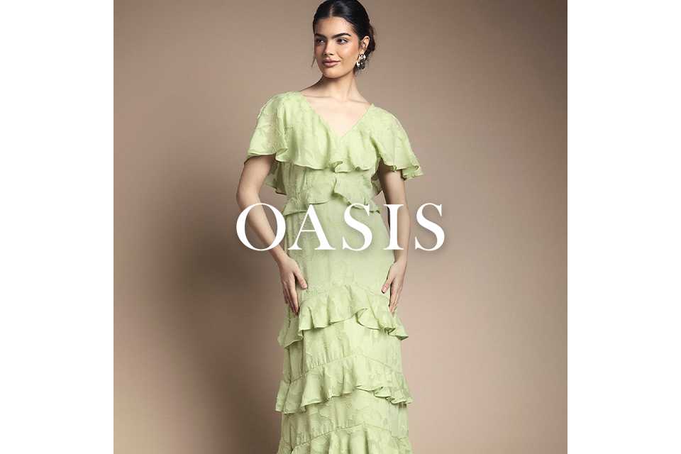 Person wearing a light green maxi dress with multiple cascading ruffle tiers.