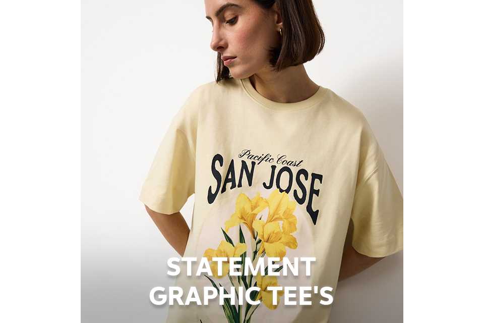 Woman wearing a butter yellow t-shirt with yellow flowers on the front.