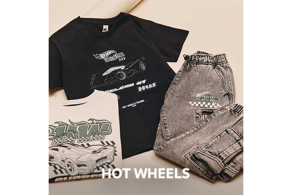 Flat lay of a black Hot Wheels T-shirt with car graphics, paired with grey joggers and additional printed tops.
