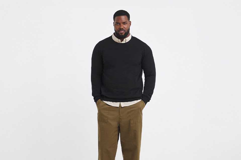 Relaxed smart‑casual workwear outfit with knit and tailored trousers.