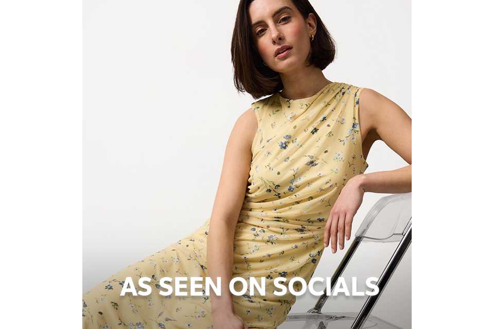 Model wearing a neutral long coat styled for social media fashion trends.