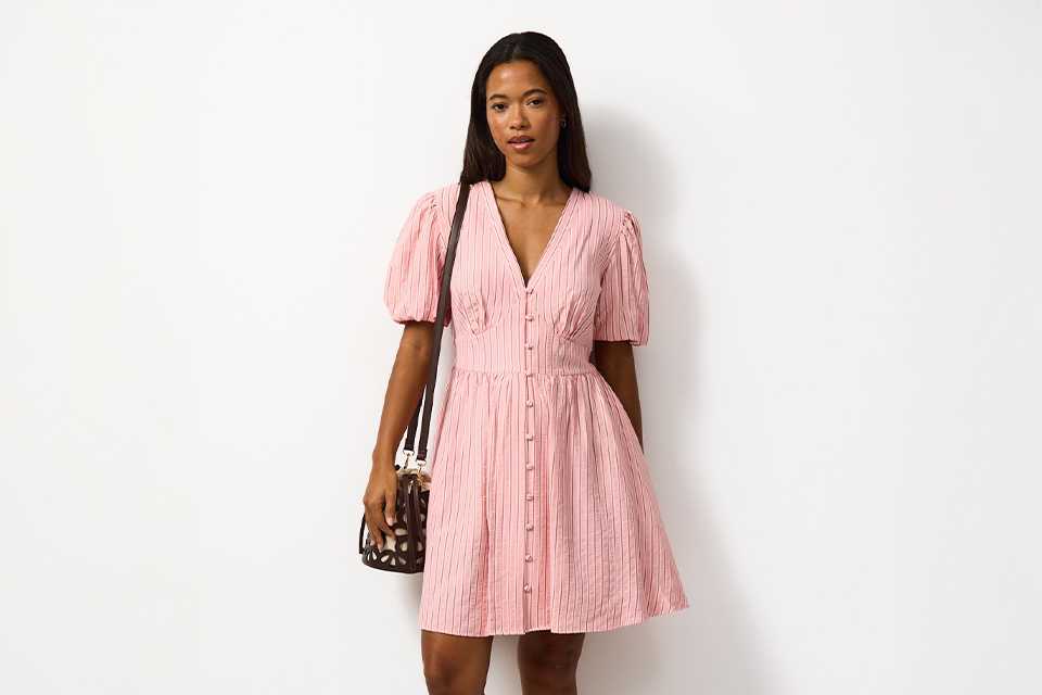 Light summer dress styled with minimal accessories, ideal for relaxed holiday outfits in warm climates.