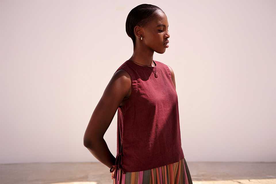 Sleeveless summer top in a bold colour, styled with a printed skirt for a breathable warm‑weather outfit.