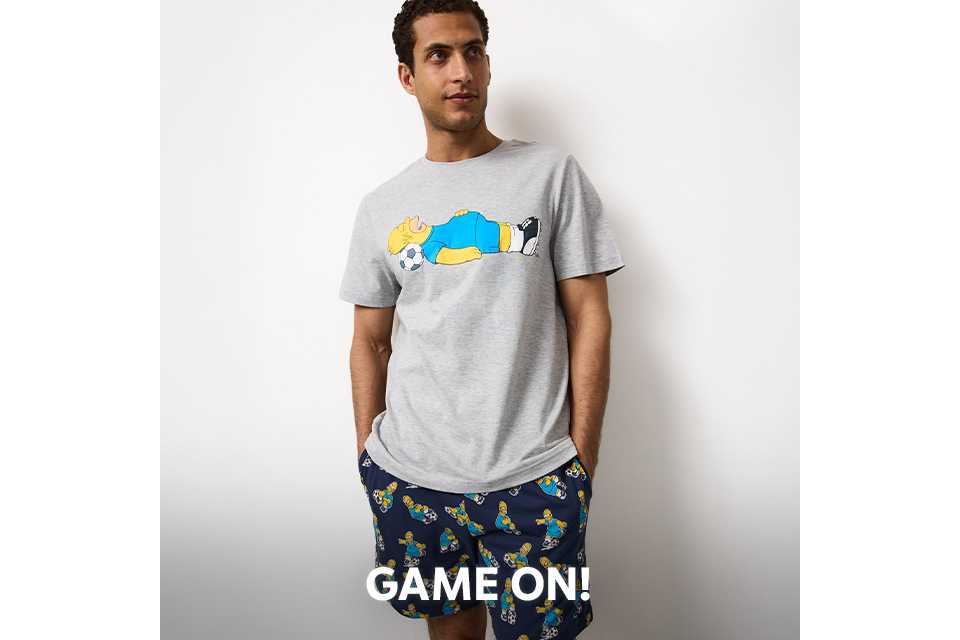Men’s grey graphic print t-shirt with patterned pyjama shorts nightwear set.