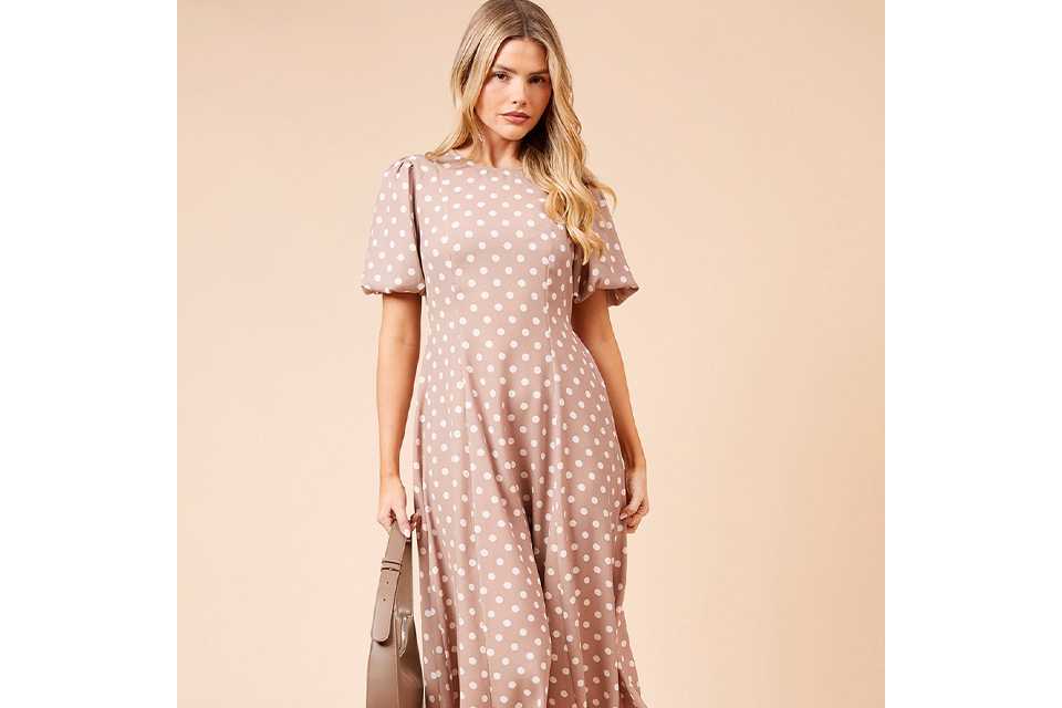 Blue and white floral long sleeve midi dress styled with a light blue cardigan, silver block‑heel sandals and drop earrings on a white background.