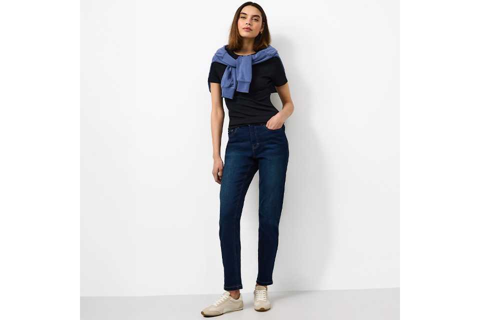 Denim dungarees styled with navy T-shirt for practical countryside staycation outfit.