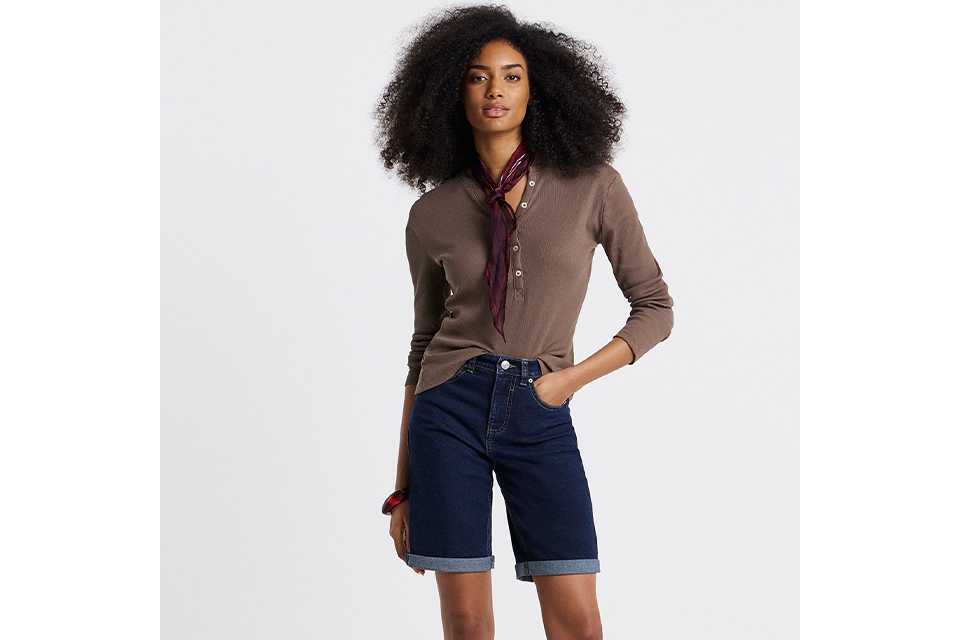 Brown long sleeve top styled with denim shorts and belt for coastal holiday outfit ideas.