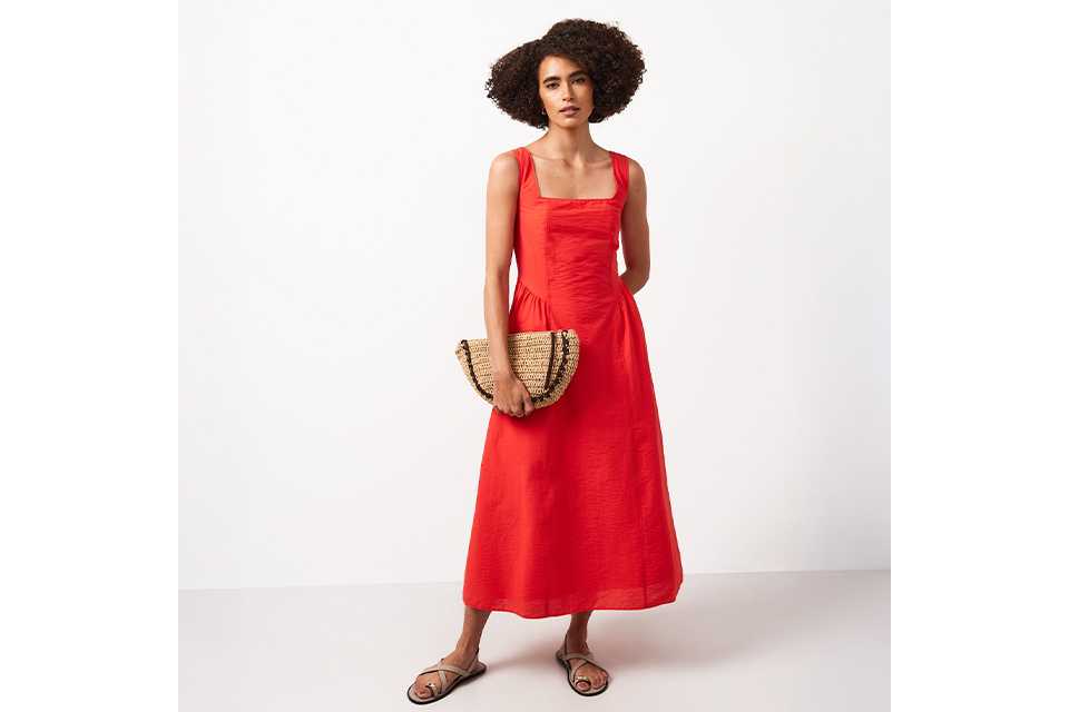 Woman wearing a red midi dress.