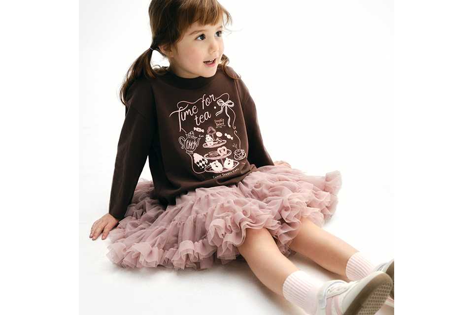 Kids' tea party graphic sweatshirt dress featuring a chocolate brown top with a layered blush pink ruffle tutu skirt.