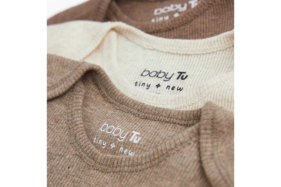 Set of ribbed baby bodysuits in neutral cream and beige tones, featuring envelope necklines and soft stretch fabric for comfortable everyday infant wear.