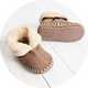 Taupe baby slippers with plush fleece lining and non-slip soles for cosy indoor comfort.