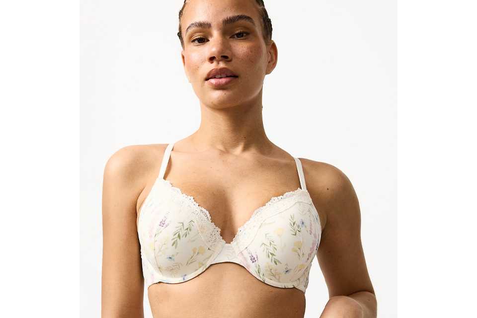 Women's white floral print T-shirt bra with multicoloured floral pattern, padded cups, underwired support and adjustable shoulder straps.