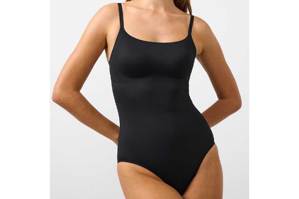 Black seamless shaping bodysuit with thin adjustable straps and smooth sculpting design.