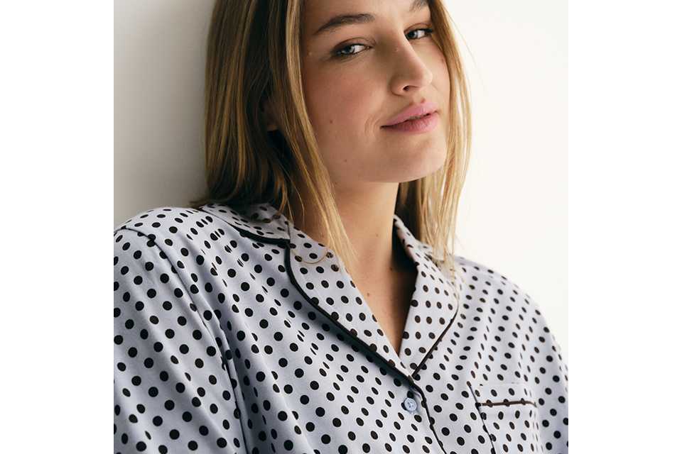 Women's white cotton pyjama shirt with black polka dot print, breathable sleepwear for comfortable cooler-weather nights.