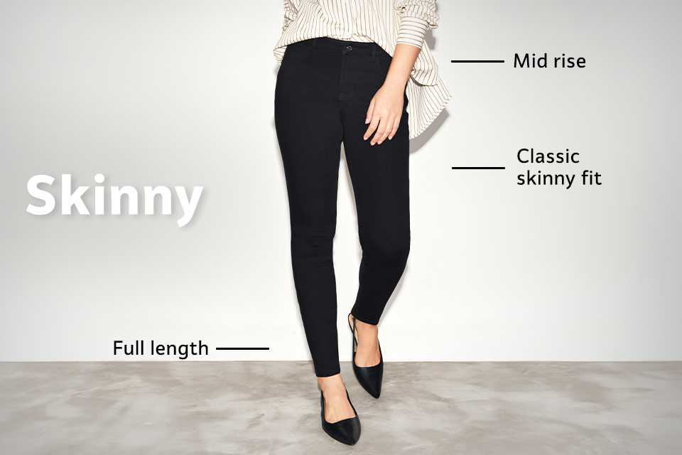 Mid-rise black skinny jeans with classic skinny fit and full-length design, styled with loafers and a striped shirt.