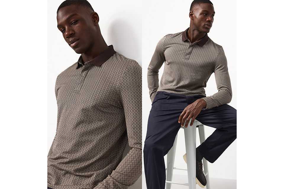 A man wearing a neutral herringbone long sleeve top with smart trousers and lace up shoes.
