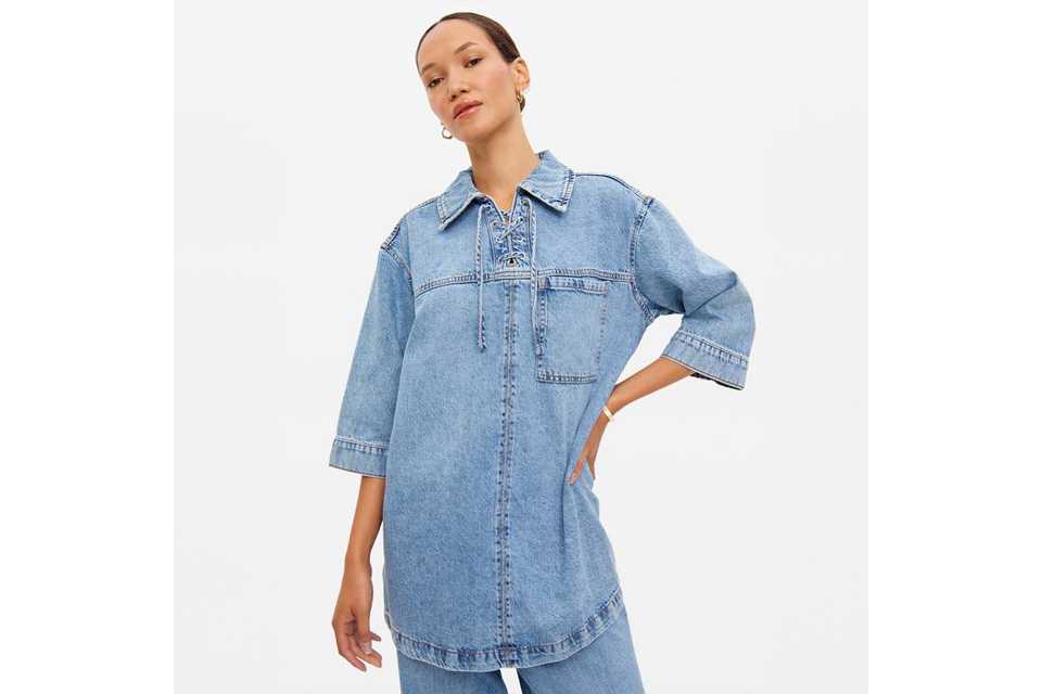 model wearing denim shirt.