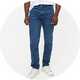 Men's white crew neck T-shirt paired with blue slim-fit jeans and white trainers for a casual everyday look.