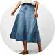 Light wash denim midi skirt with a flared silhouette, panel detailing, and a high-waisted fit, styled with a cream sleeveless top and ballet flats.