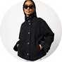 Black denim jacket with a high stand collar, button-front fastening, and side pockets, styled with sunglasses for a modern casual look.