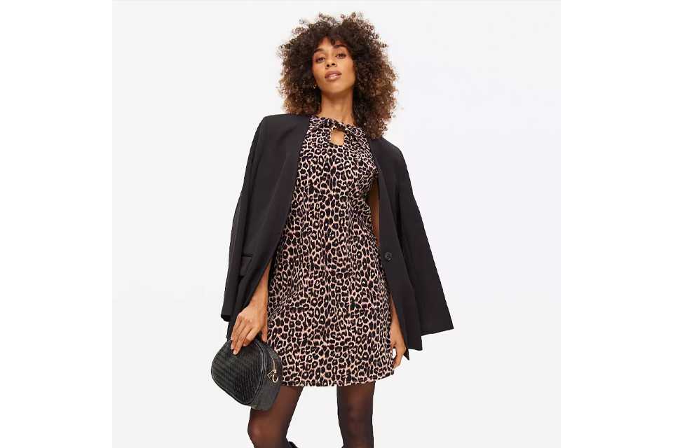 Woman wearing leapord print corduroy dress.