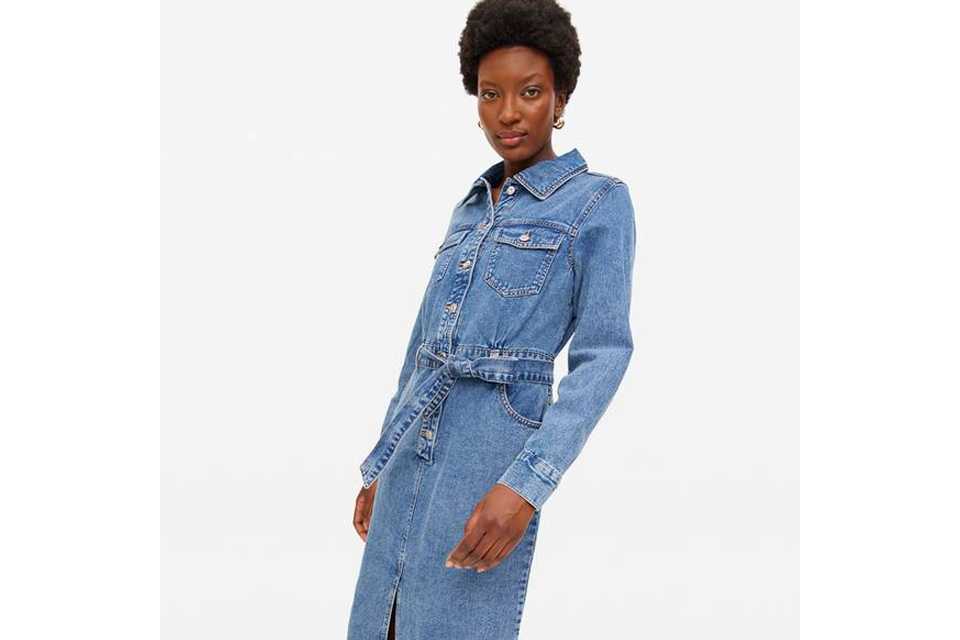 Woman wearing denim shirt dress.