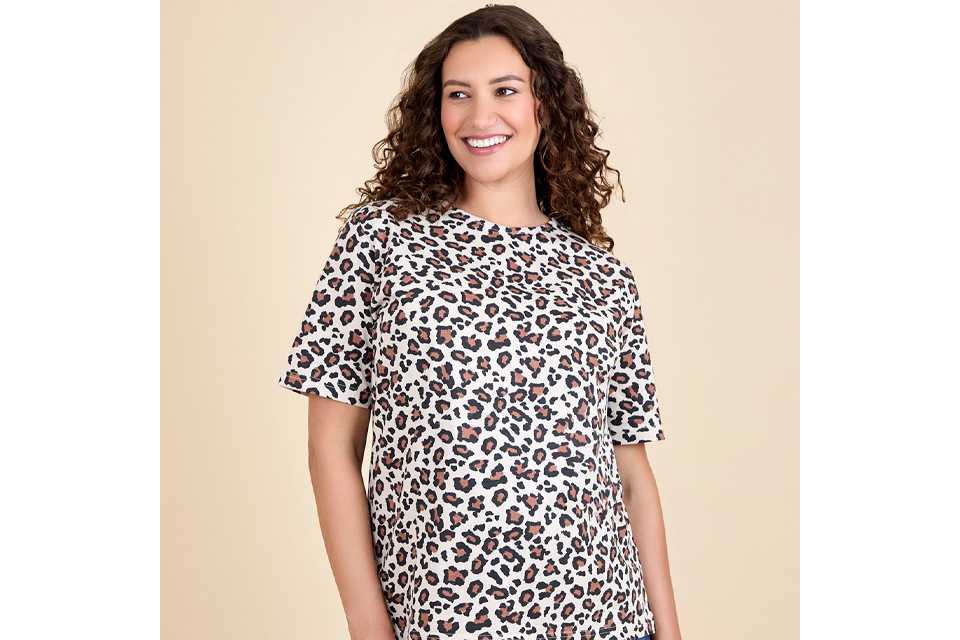Woman wearing leapord print top.