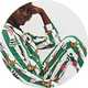 Model wearing green striped Disney Bambi Christmas pyjamas with festive reindeer, wreath and bauble prints.