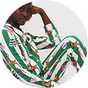 Model wearing green striped Disney Bambi Christmas pyjamas with festive reindeer, wreath and bauble prints.