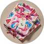 Wrapped Christmas pyjama gift set with festive character print nightwear.