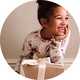 Child wearing festive Christmas pyjamas beside a Christmas Eve gift box.