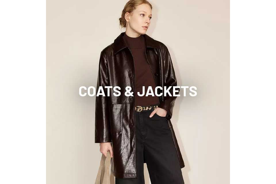 Woman wearing brown patent faux leather coat.