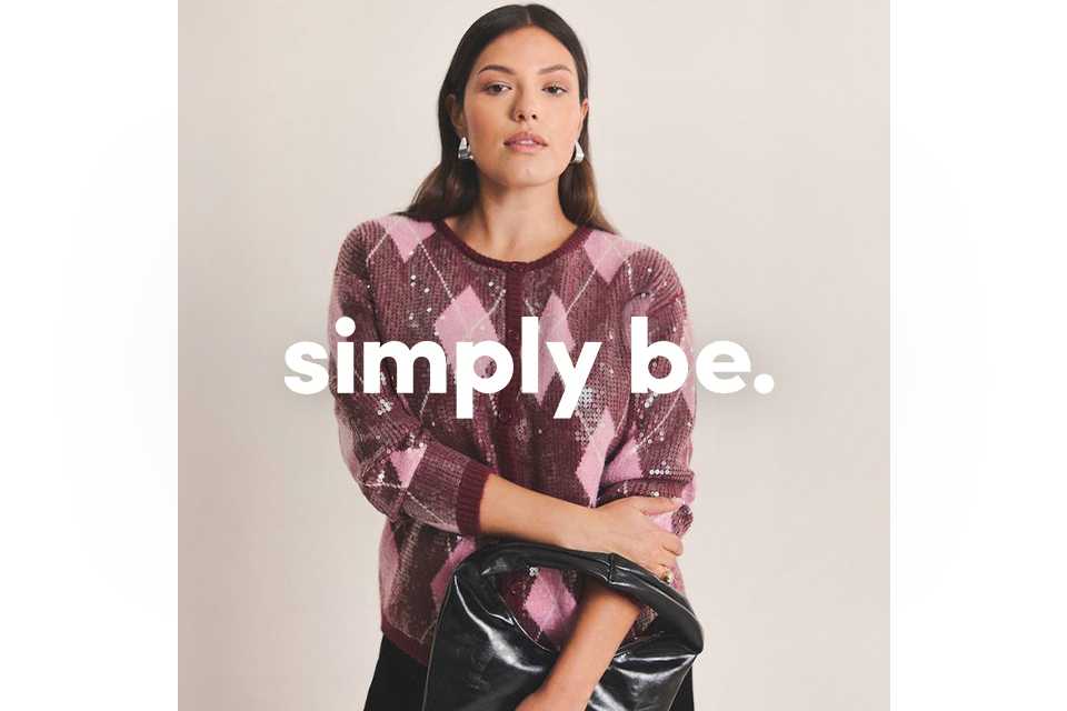 A woman wearing pink and burgundy sequin cardigan.