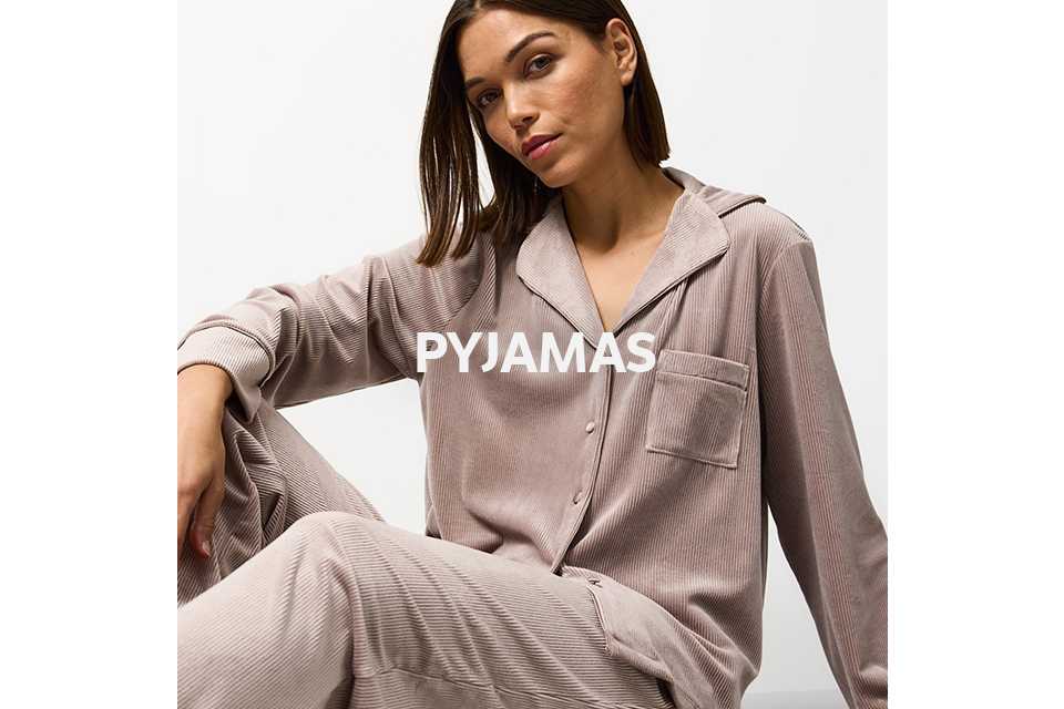 Woman wearing traditional mink ribbed velour pyjamas.