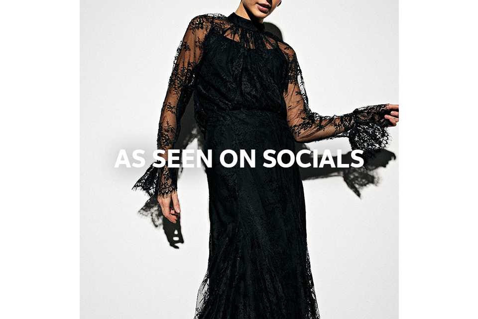 Woman wearing full length black lace skirt.