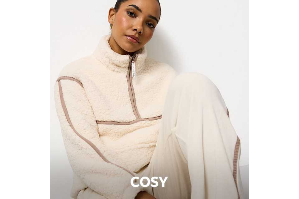 Cream fleece zip-up top paired with loose cream trousers, styled as cosy nightwear.